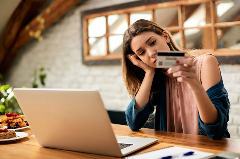 young woman holding maxed out credit card