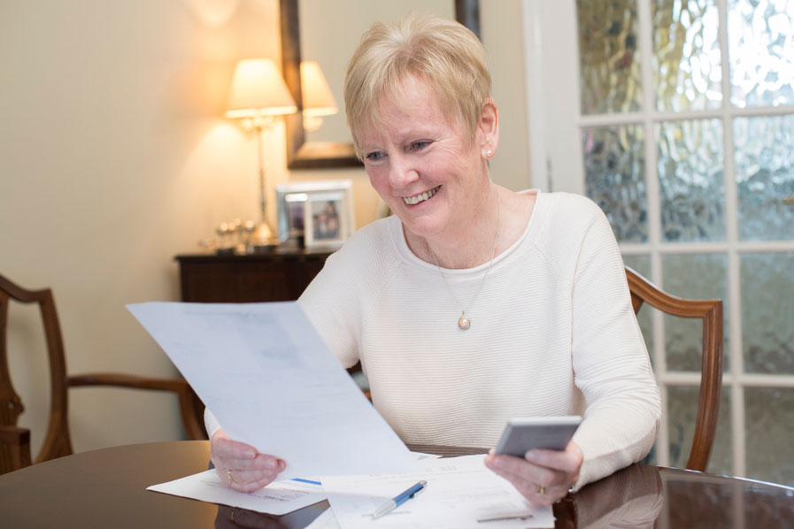 smiling senior lady checking finances