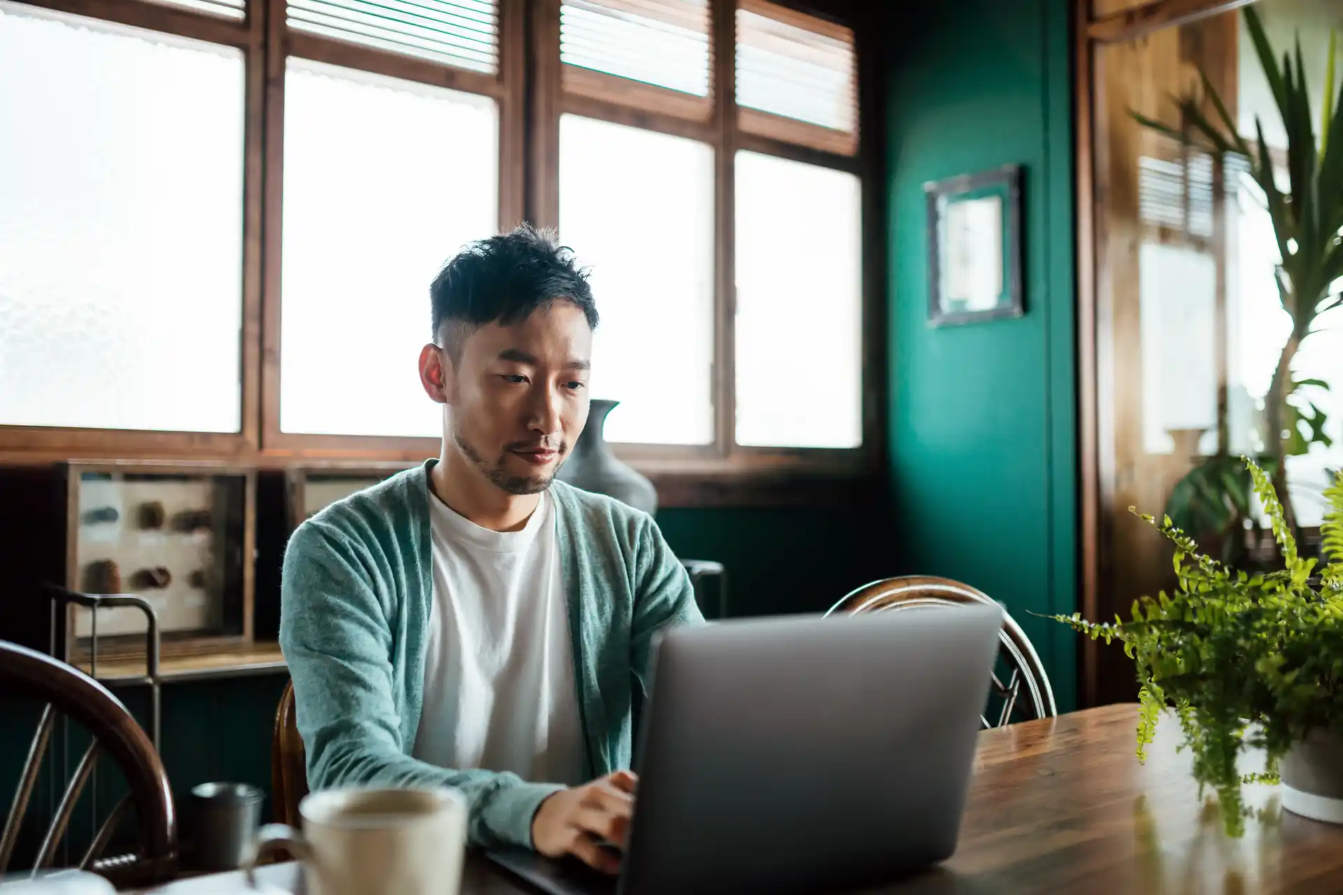 man on laptop in cafe